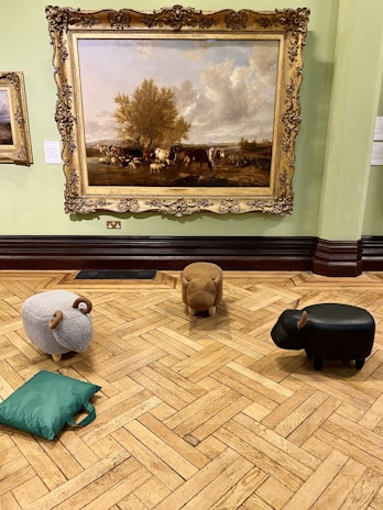 An overhead shot of a crafts with cows event showing guests painting and creating with cows nearby.