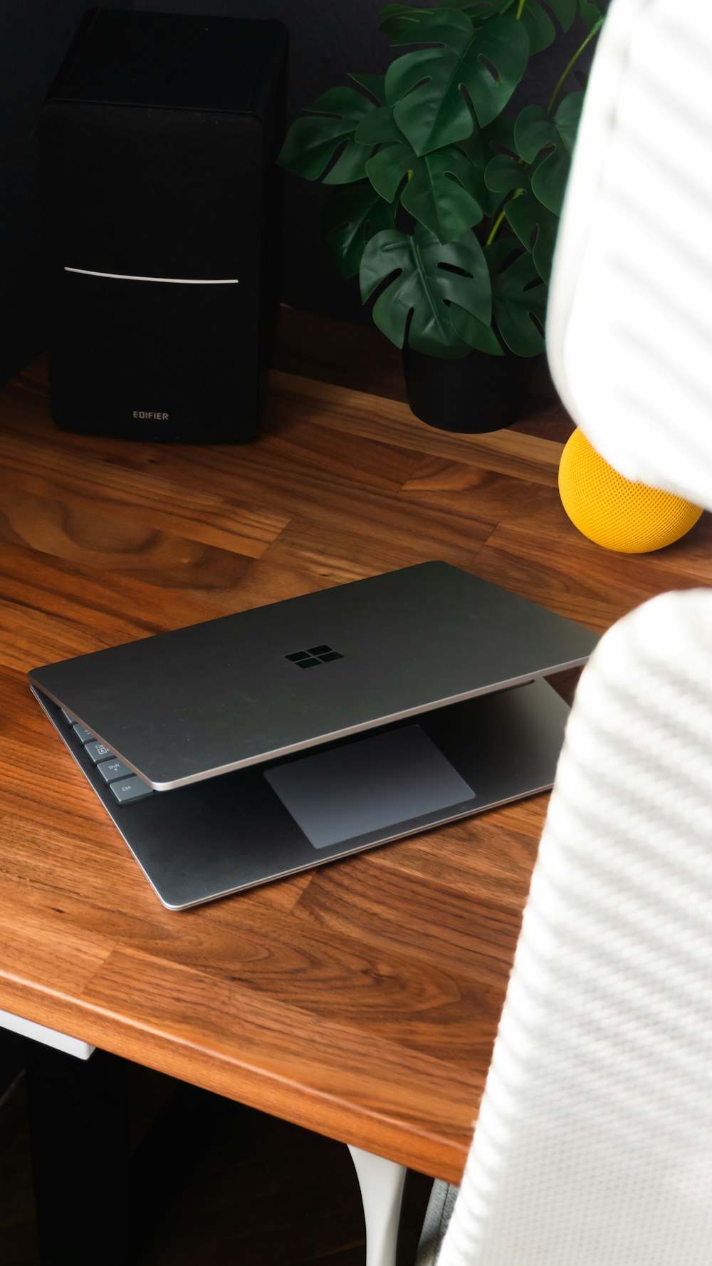 a laptop computer sitting on top of a wooden desk