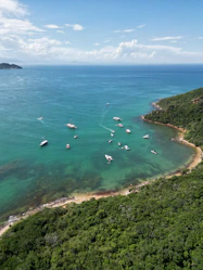 a group of boats floating on top of a body of water