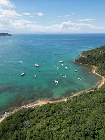 a group of boats floating on top of a body of water