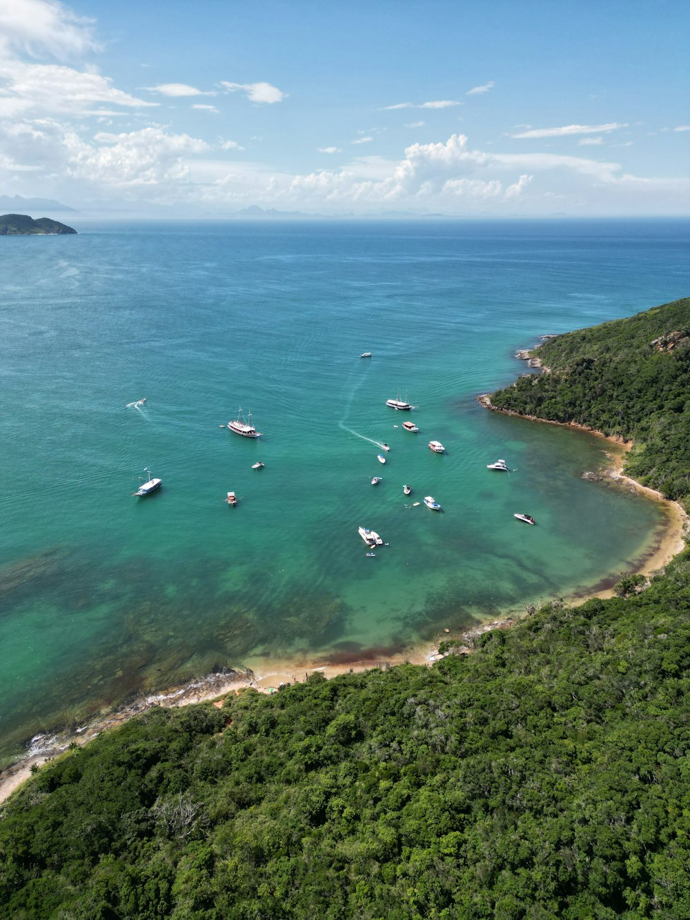 a group of boats floating on top of a body of water