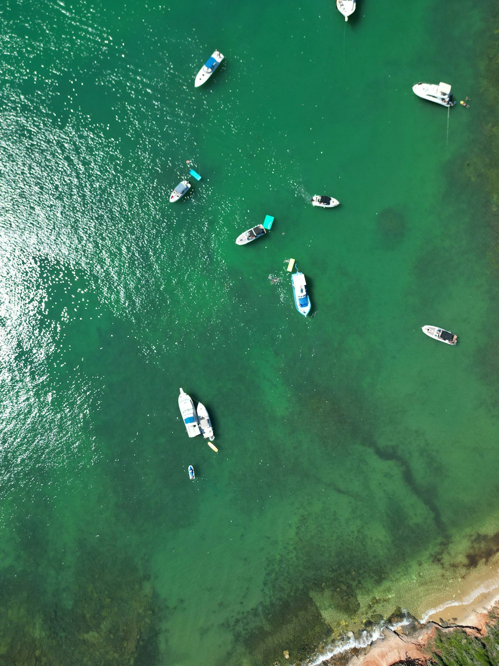 a group of boats floating on top of a body of water