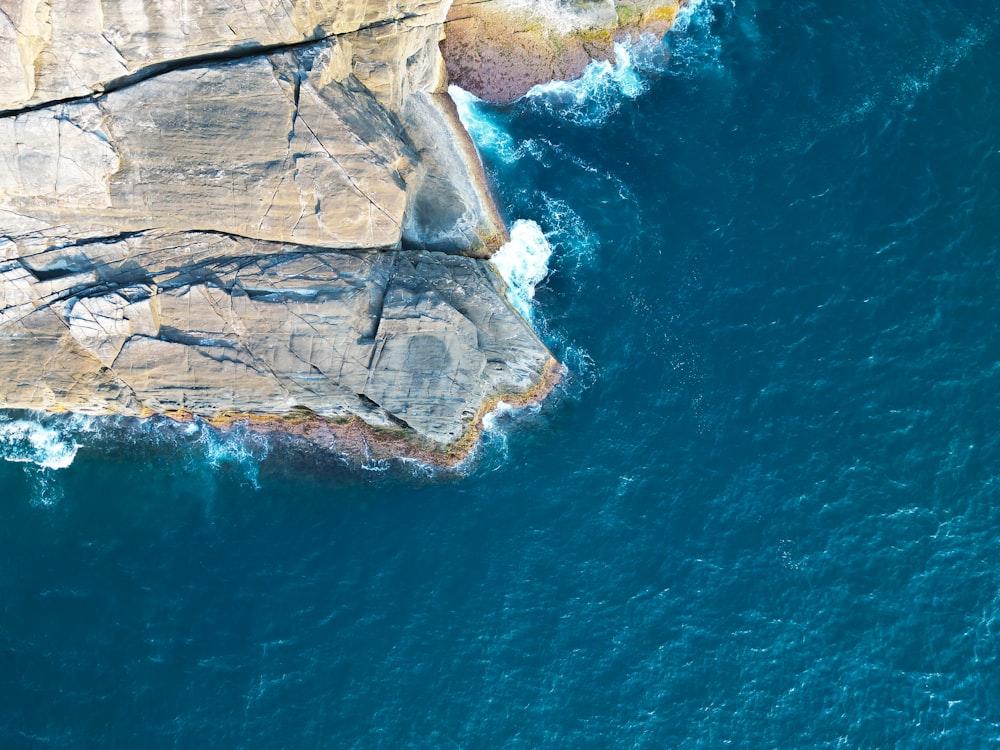 an aerial view of the ocean and cliffs