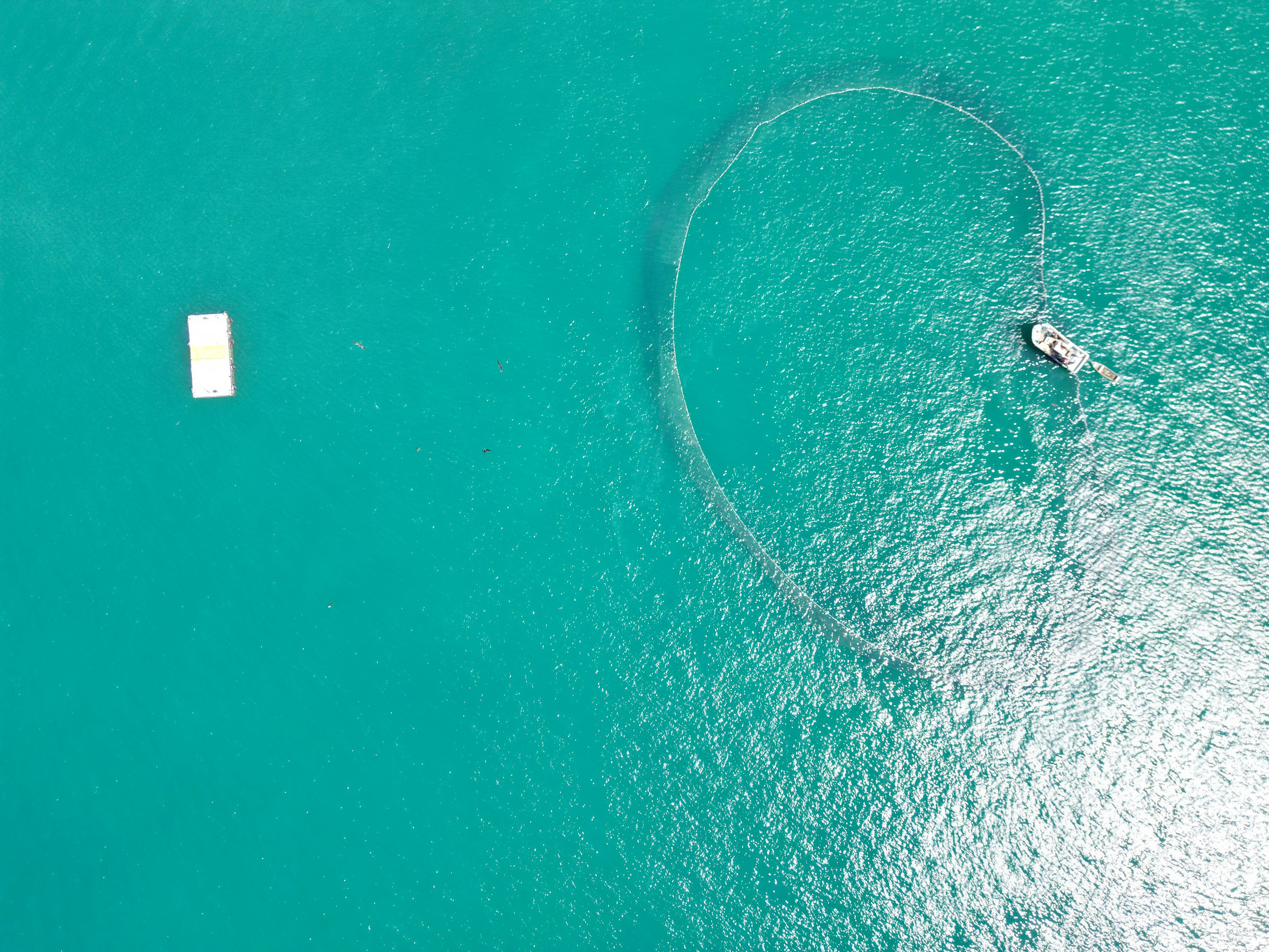 a man in a boat in the middle of the ocean