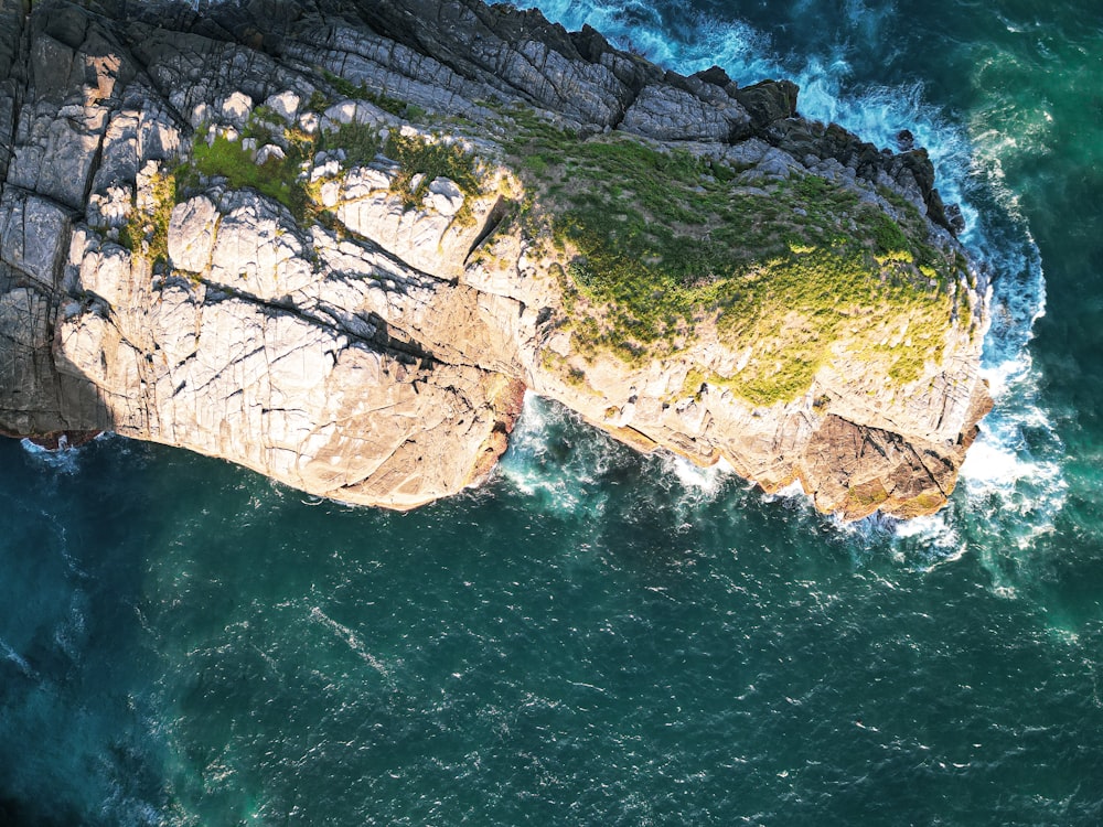 an aerial view of the ocean and cliffs