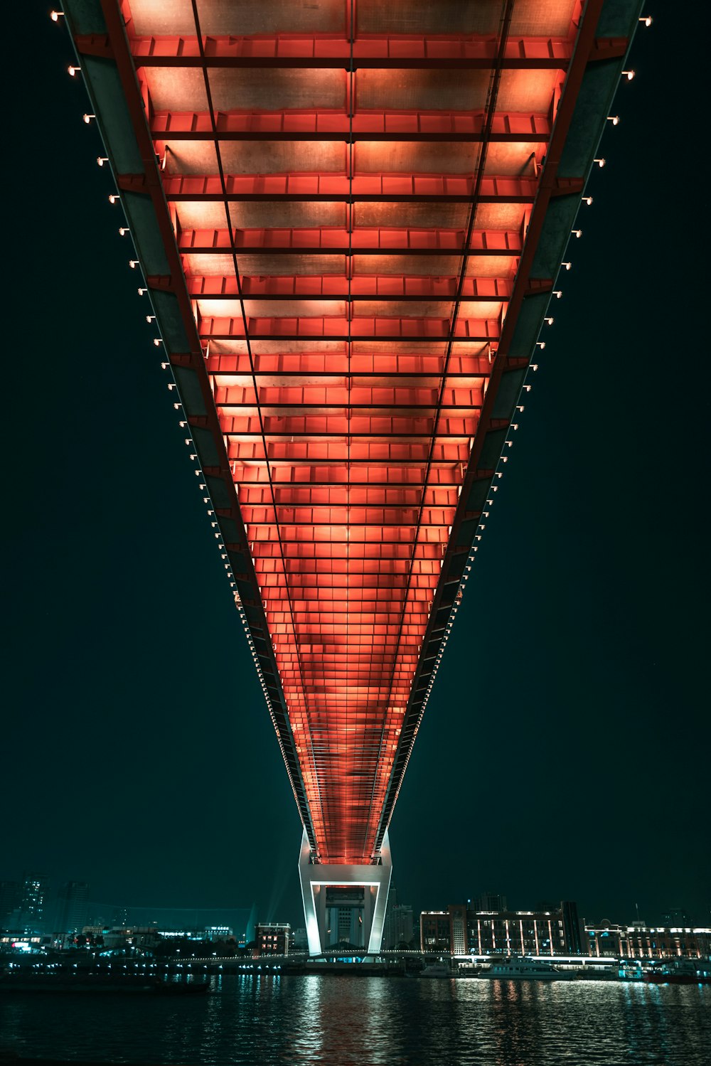 the underside of a bridge lit up at night
