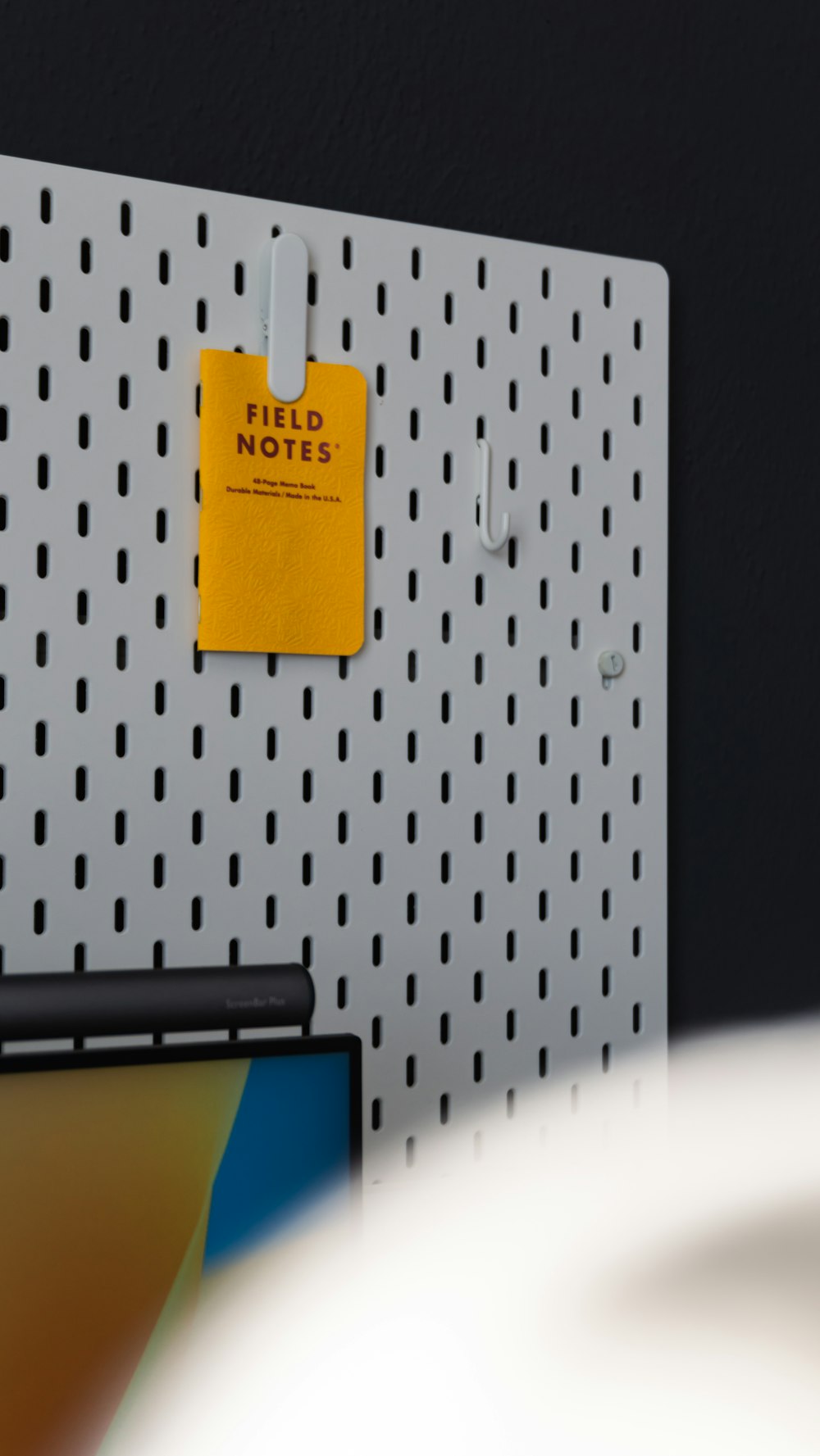 a yellow note pinned to a metal wall
