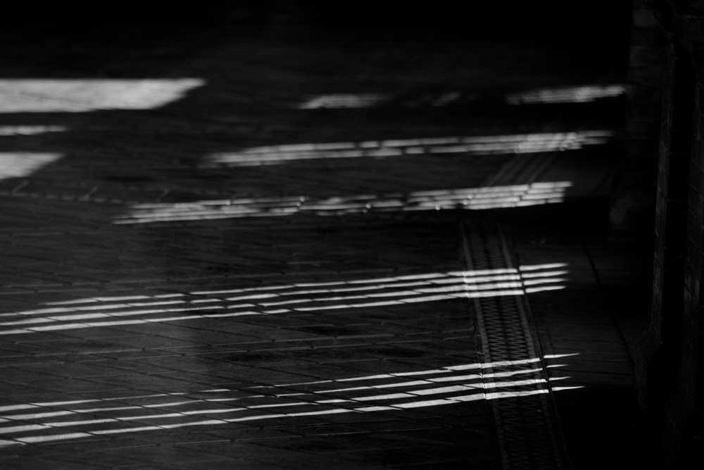 a black and white photo of a person walking down a street