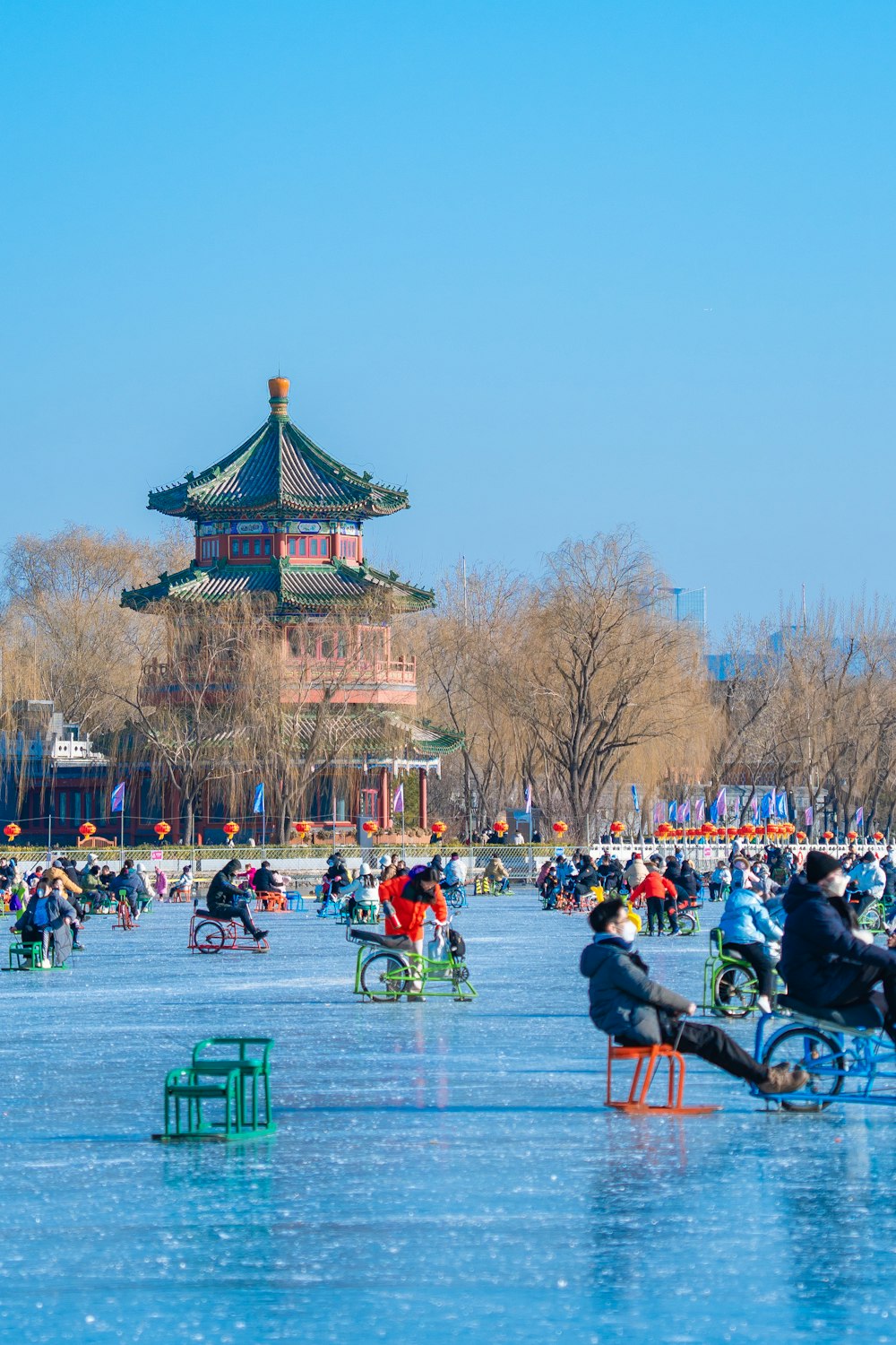 a group of people riding bikes on top of a frozen lake