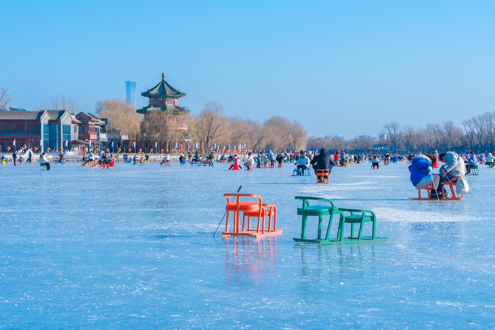 a group of people standing on top of a frozen lake