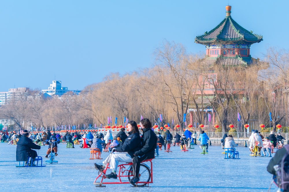 a group of people standing around in a park