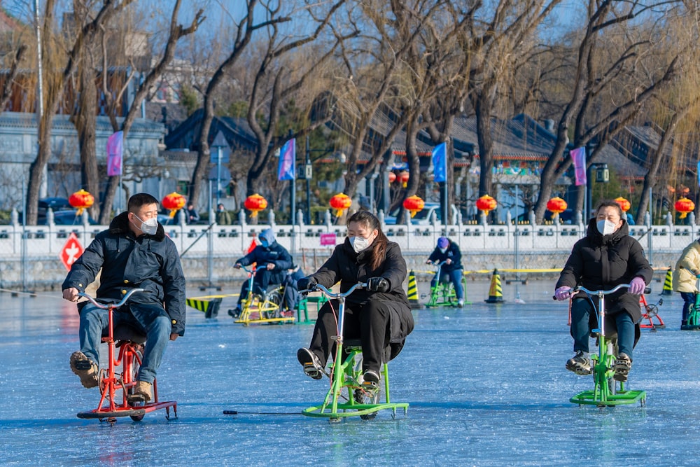 a group of people riding bikes on top of a frozen lake