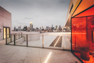 View of a rooftop terrace with city skyline in the background.