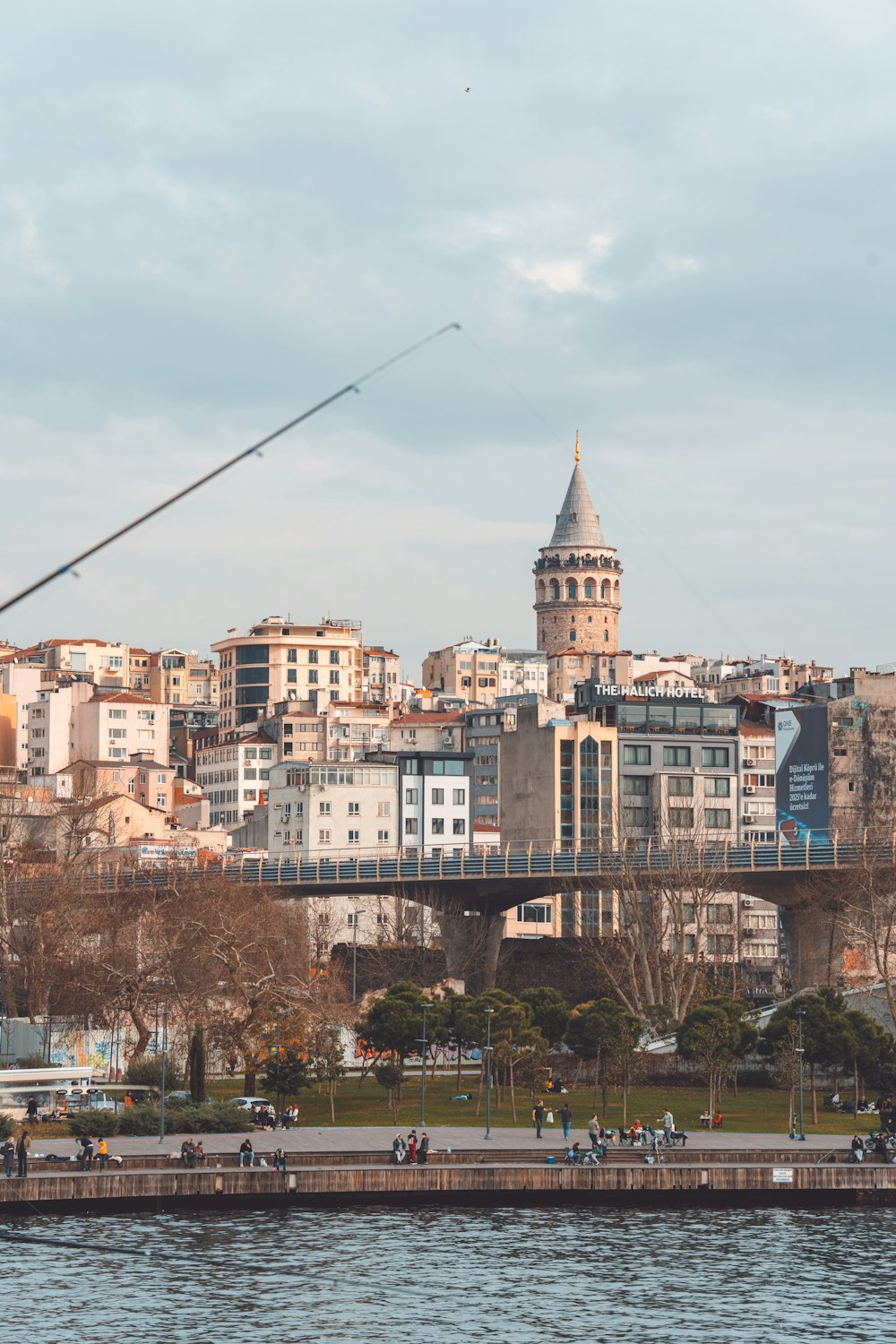 a bridge over a body of water with a city in the background