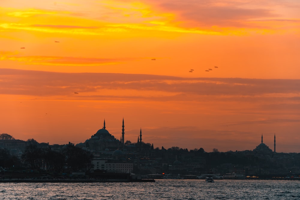 a sunset view of a city and a body of water