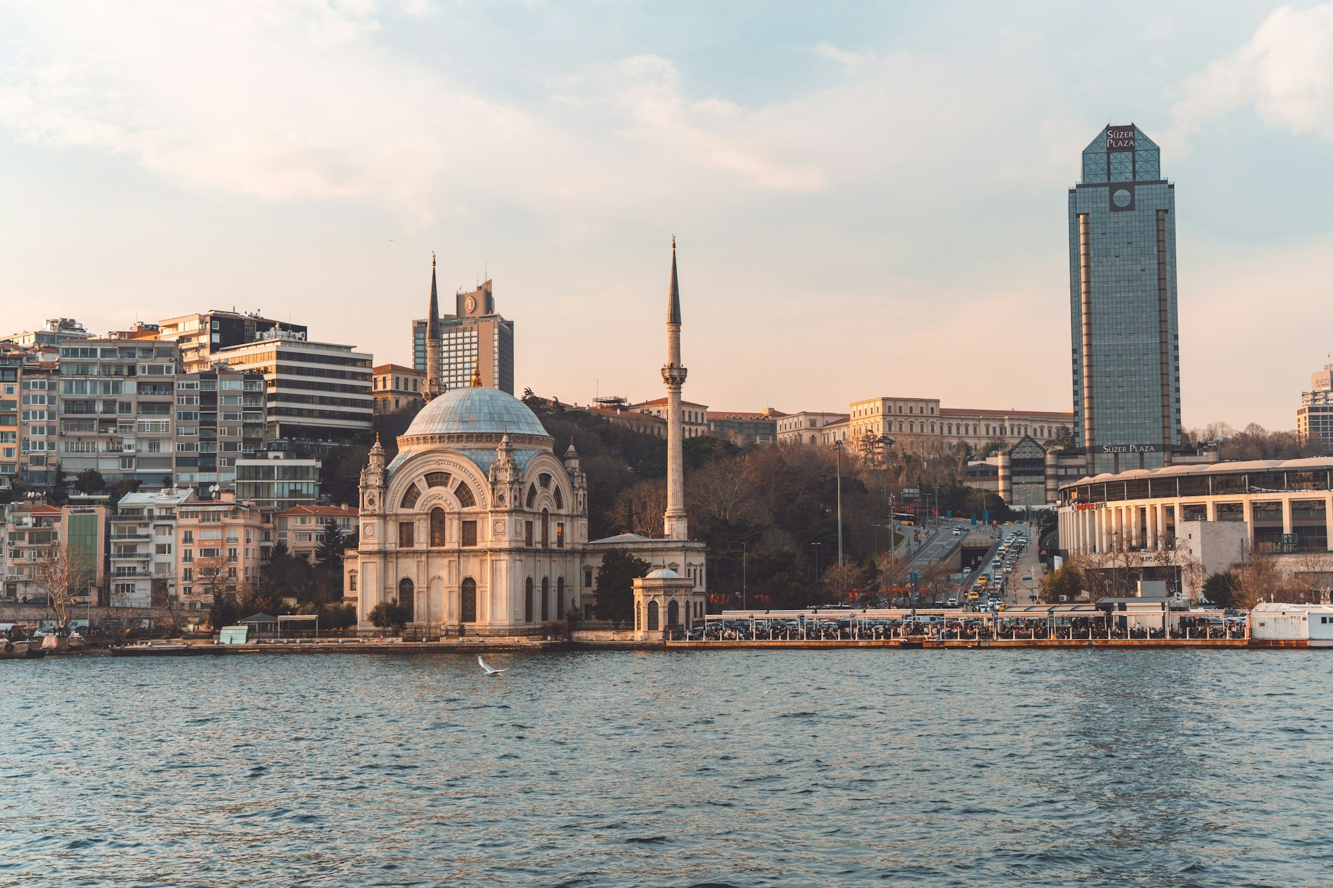 a large body of water with buildings in the background