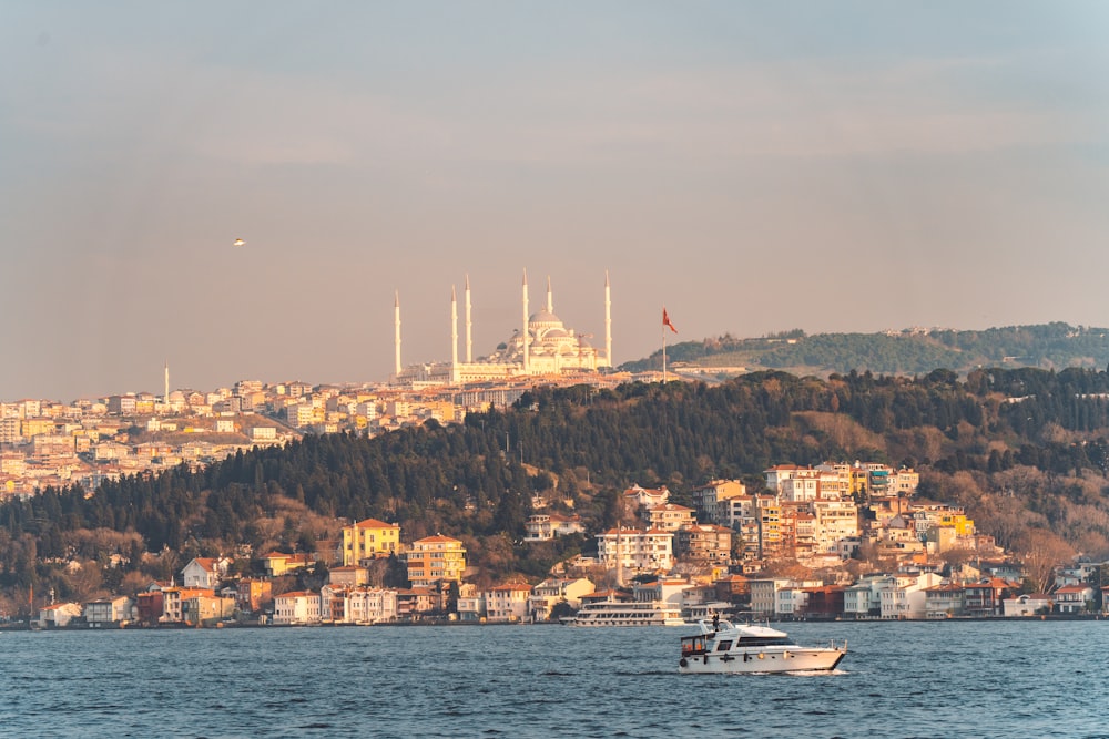 a boat in a body of water near a city