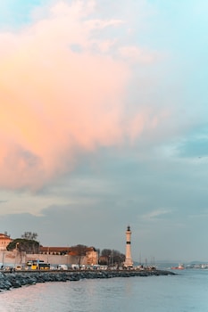 a light house sitting next to a body of water