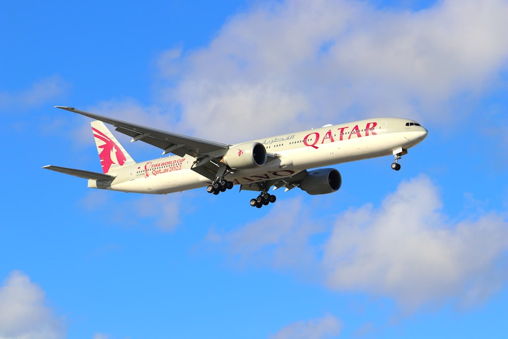 a large jetliner flying through a blue cloudy sky