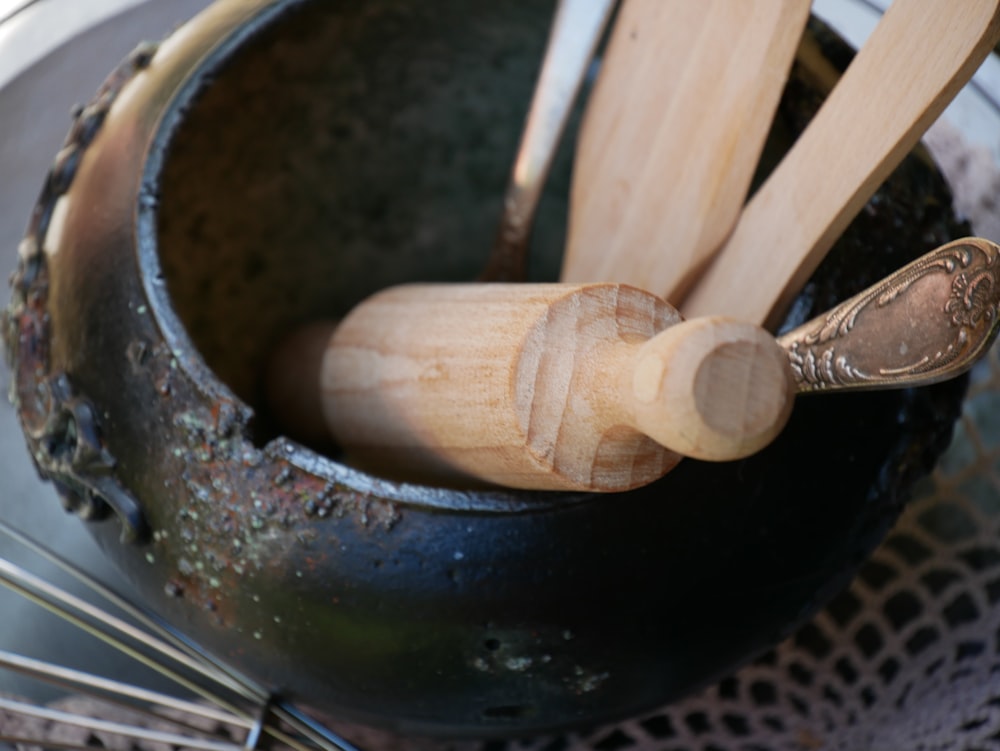 wooden utensils in a pot on a doily