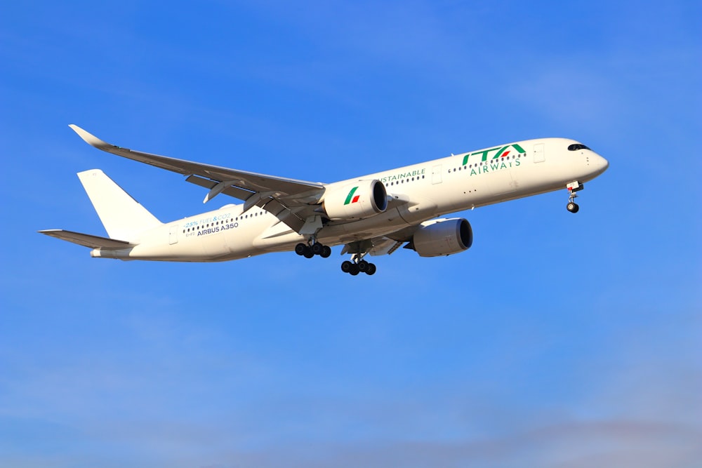 a large jetliner flying through a blue sky