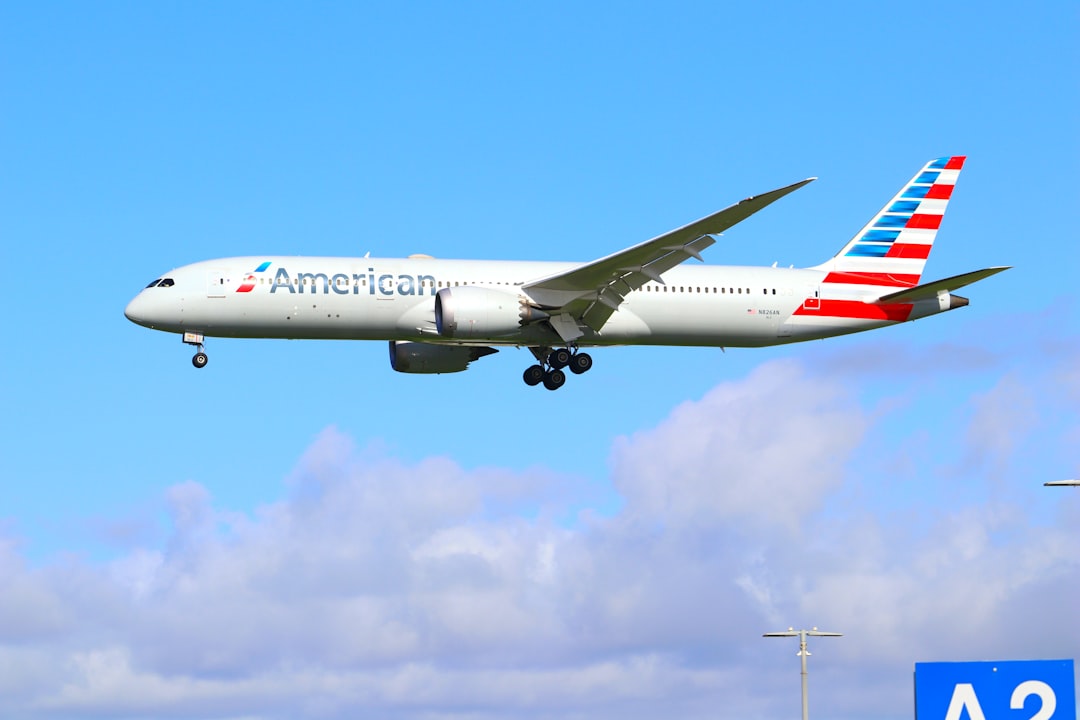 an american airlines plane flying in the sky, American Airlines Boeing 787 Landing