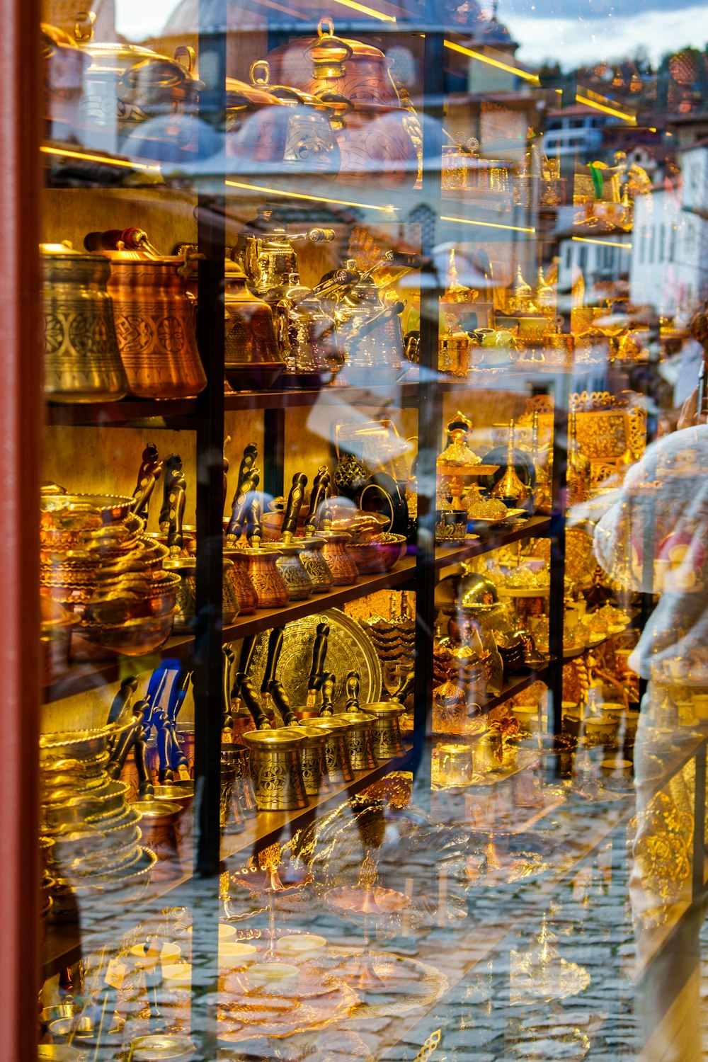 a store window with a reflection of a person in it