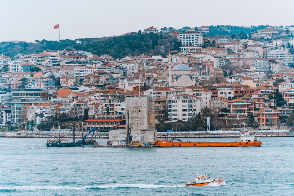 a boat in a body of water near a city