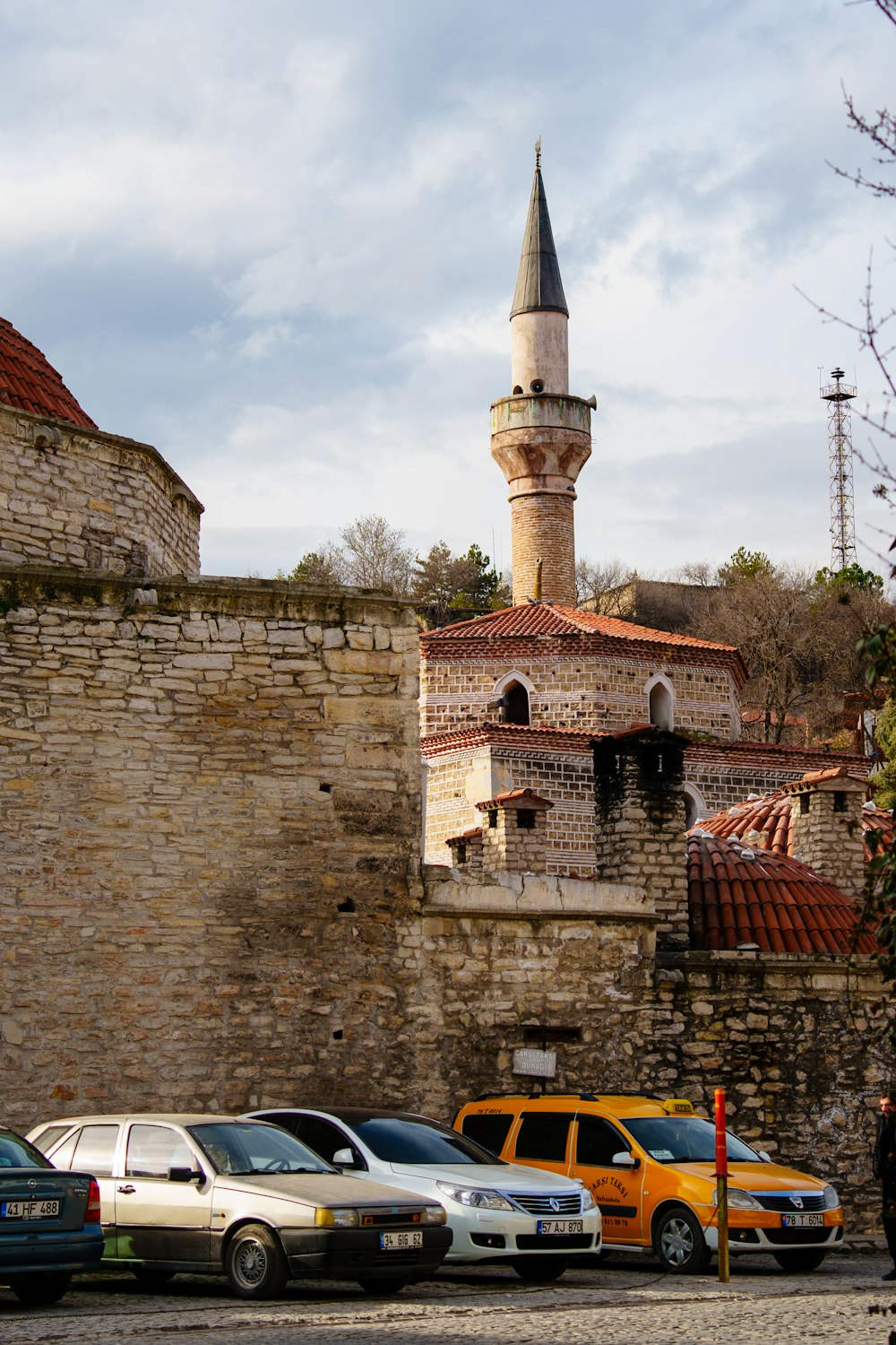 several cars parked in front of an old building