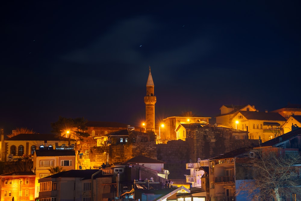 a night view of a city with a clock tower