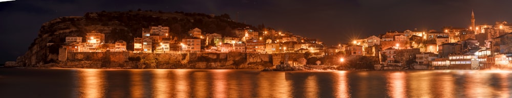 a city lit up at night by the water