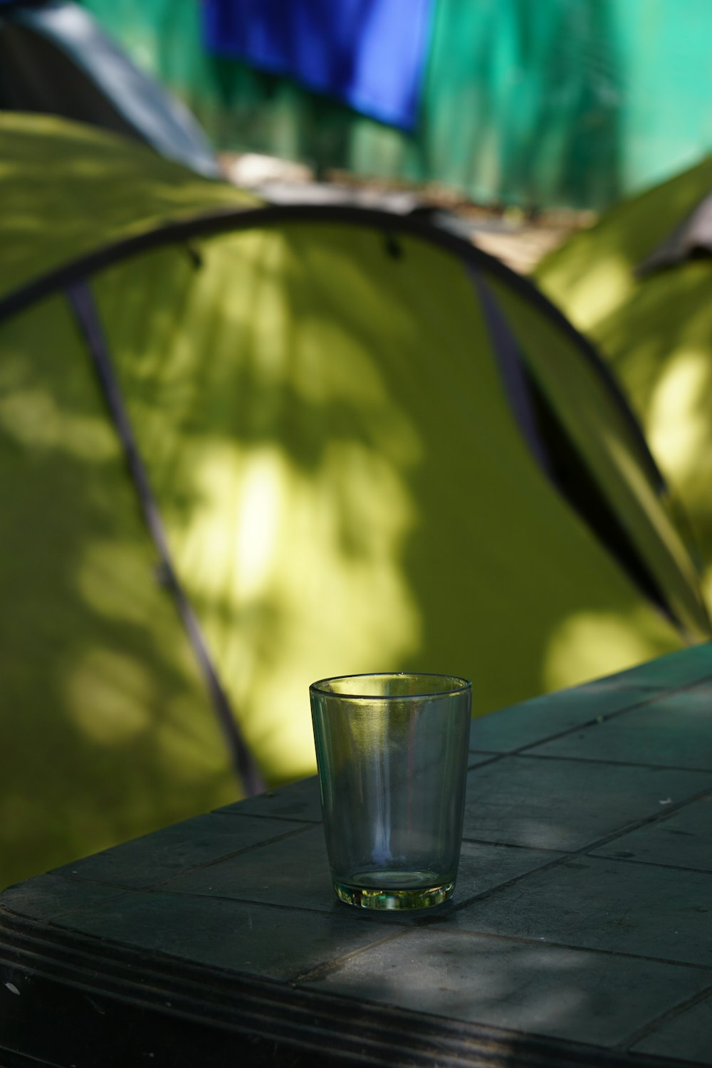 a shot glass sitting on a table in front of a tent