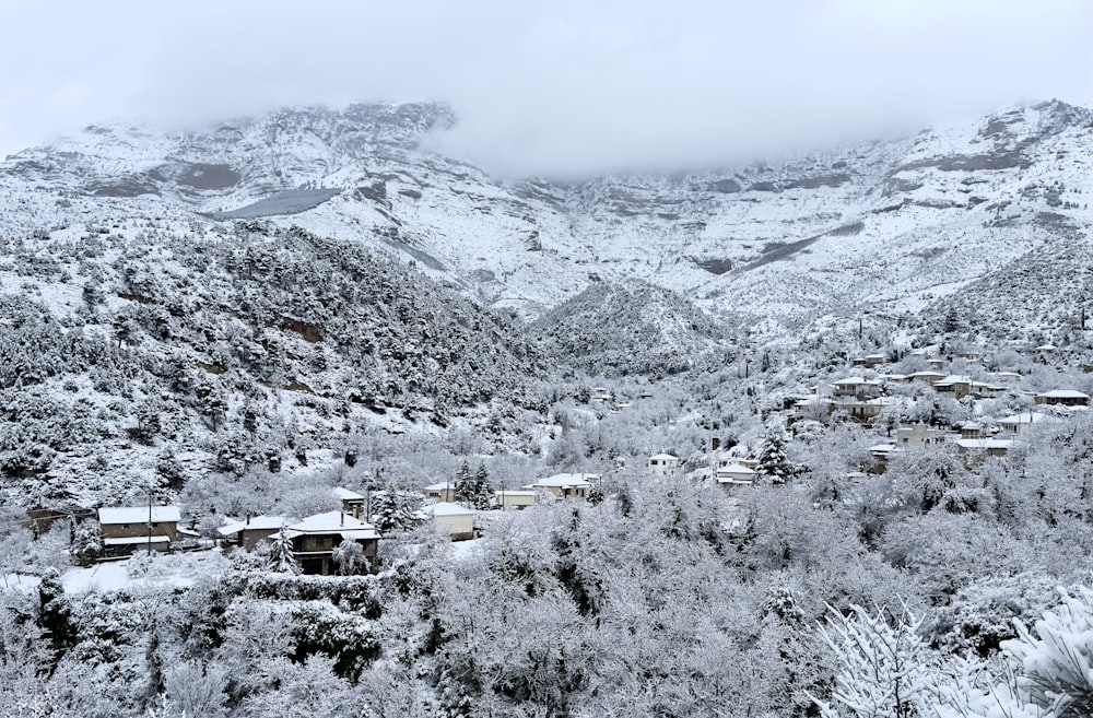 a snow covered mountain with a village in the foreground