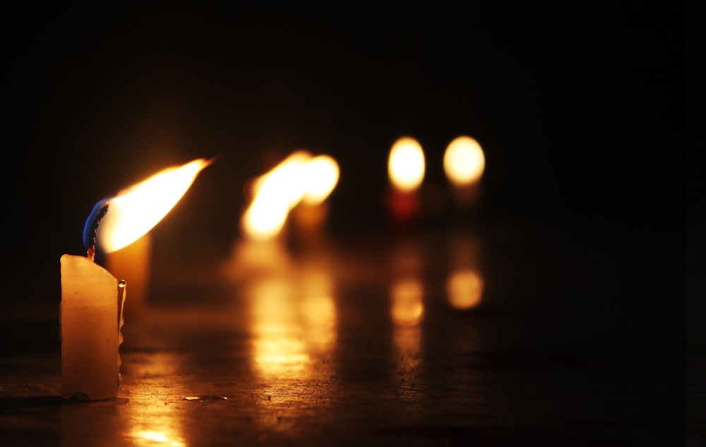 a lit candle sitting on top of a table