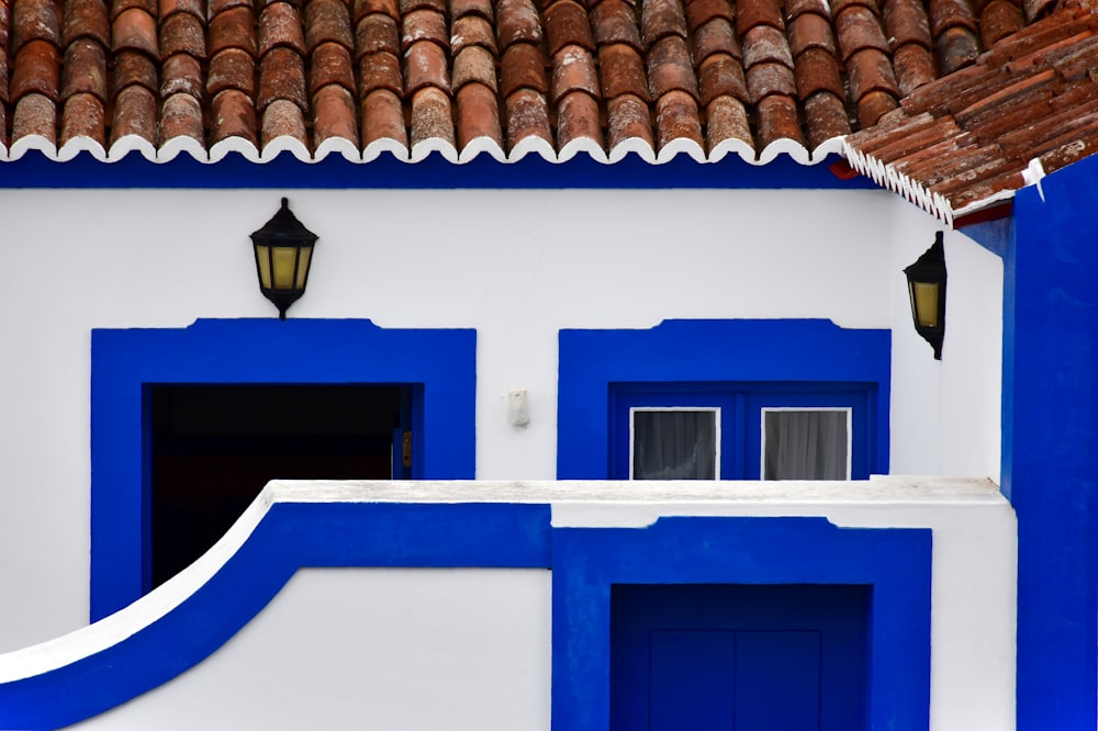 a white and blue building with a red roof