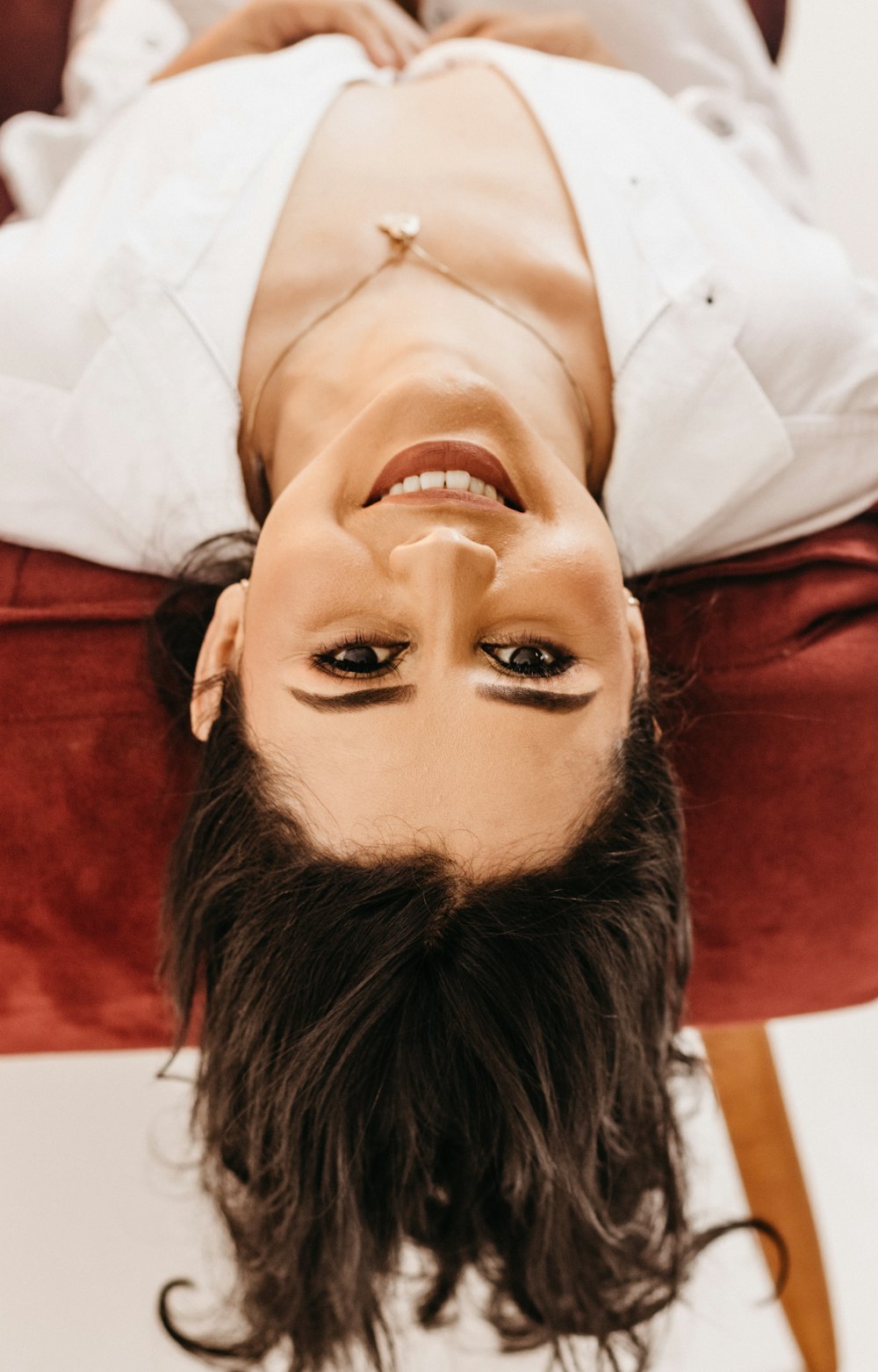 a person with a fake head laying on a chair