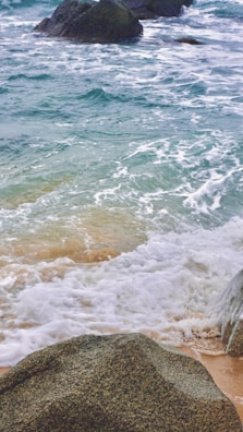 The peaceful shores of Kanyakumari where three seas meet, with waves crashing on rocks