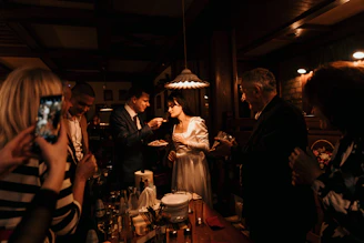 Catering staff serving guests at an elegant wedding reception.