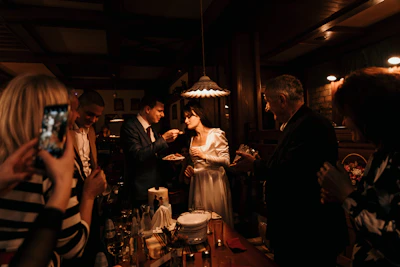 Catering staff serving guests at an elegant wedding reception.