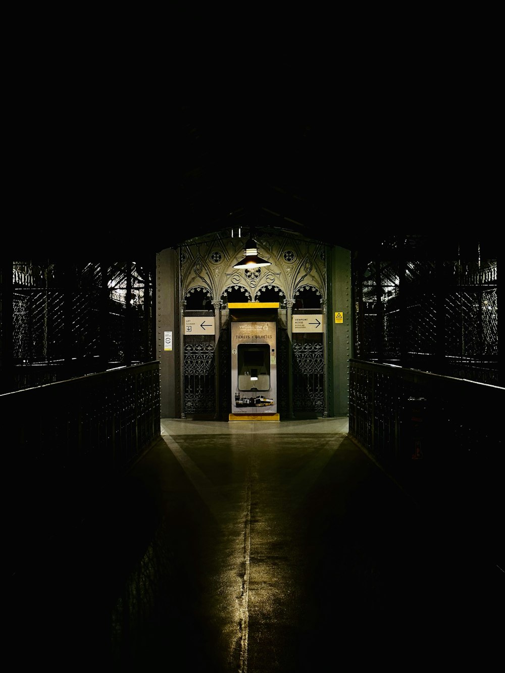 a train station at night with the lights on