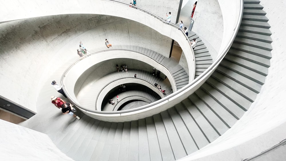 a group of people walking up and down a spiral staircase