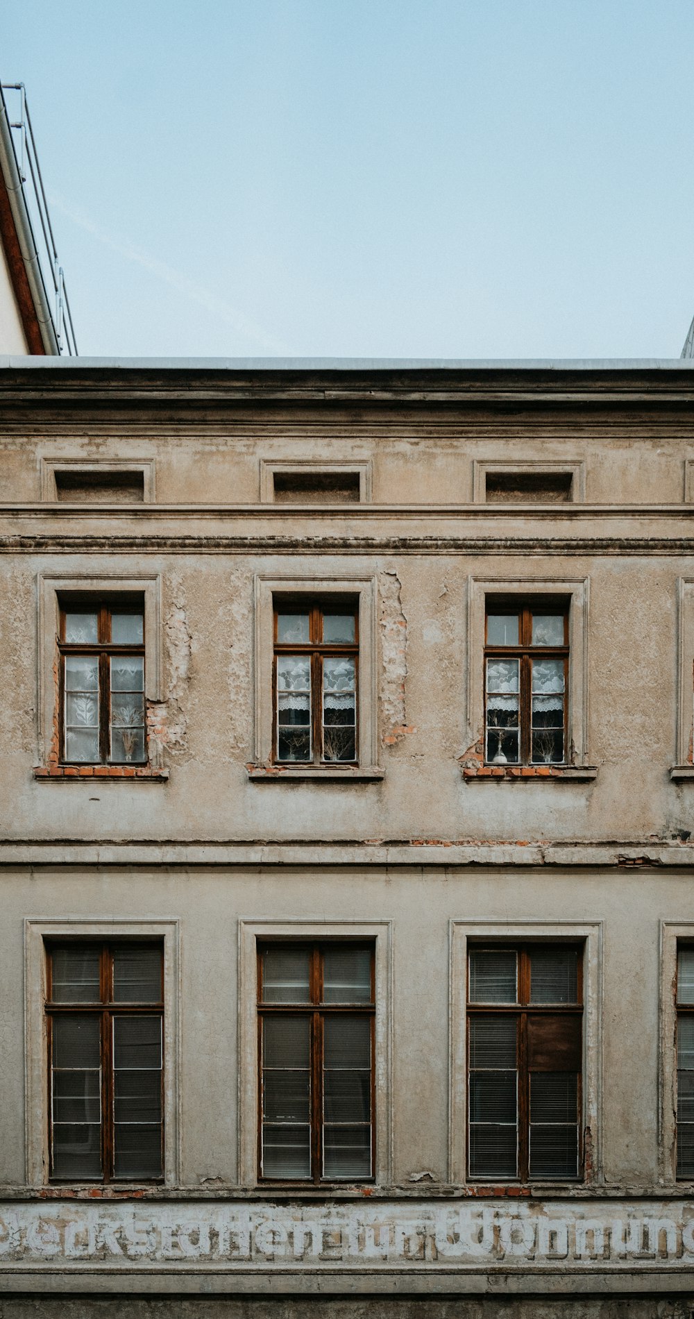 a building with windows and a clock on the side of it