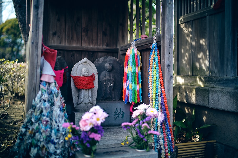 a shrine with a statue of an elephant and flowers