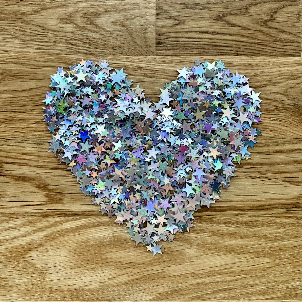 a heart made out of stars on a wooden surface