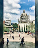 An urban plaza featuring dynamic shadows and bustling pedestrian activity.
