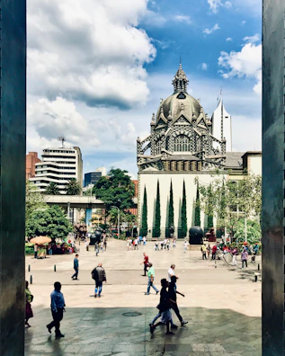 An urban plaza featuring dynamic shadows and bustling pedestrian activity.