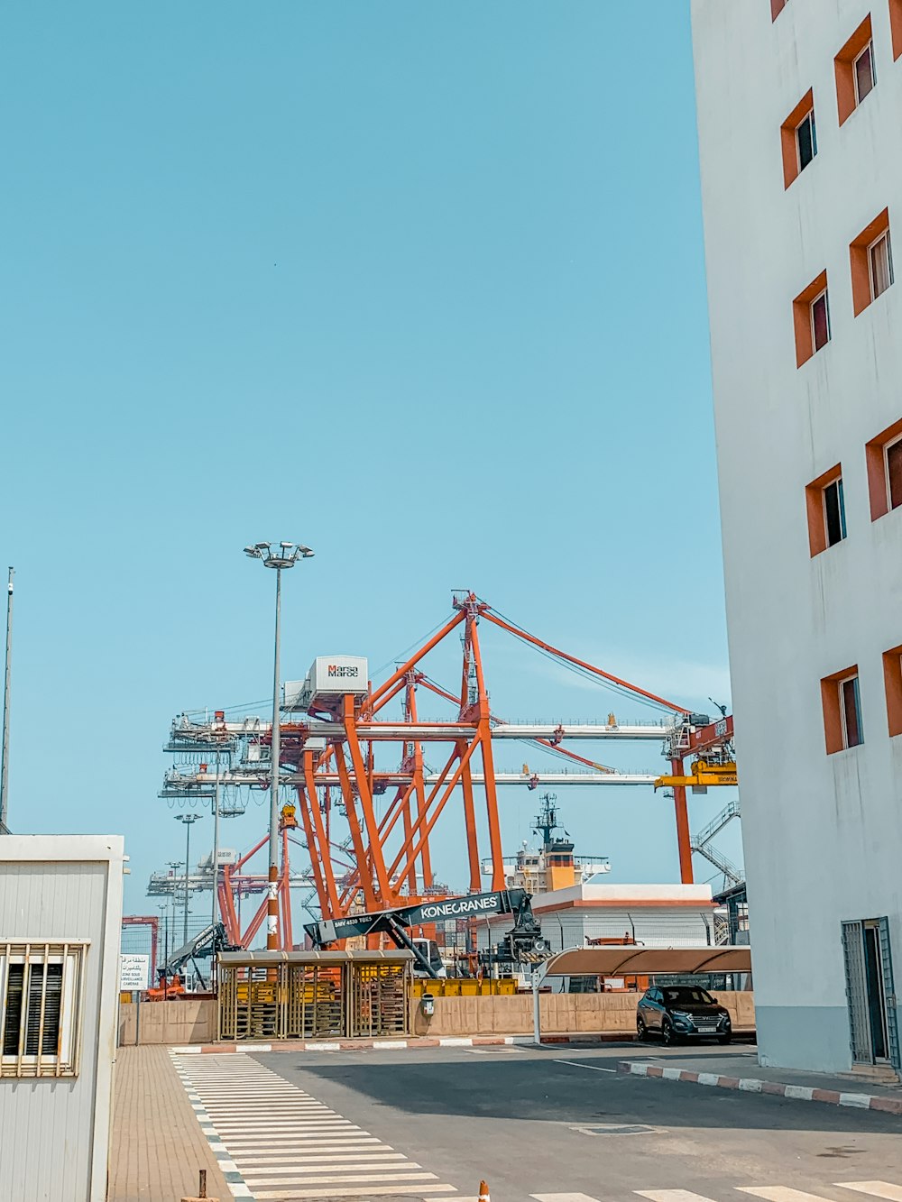 a large crane sitting next to a tall building