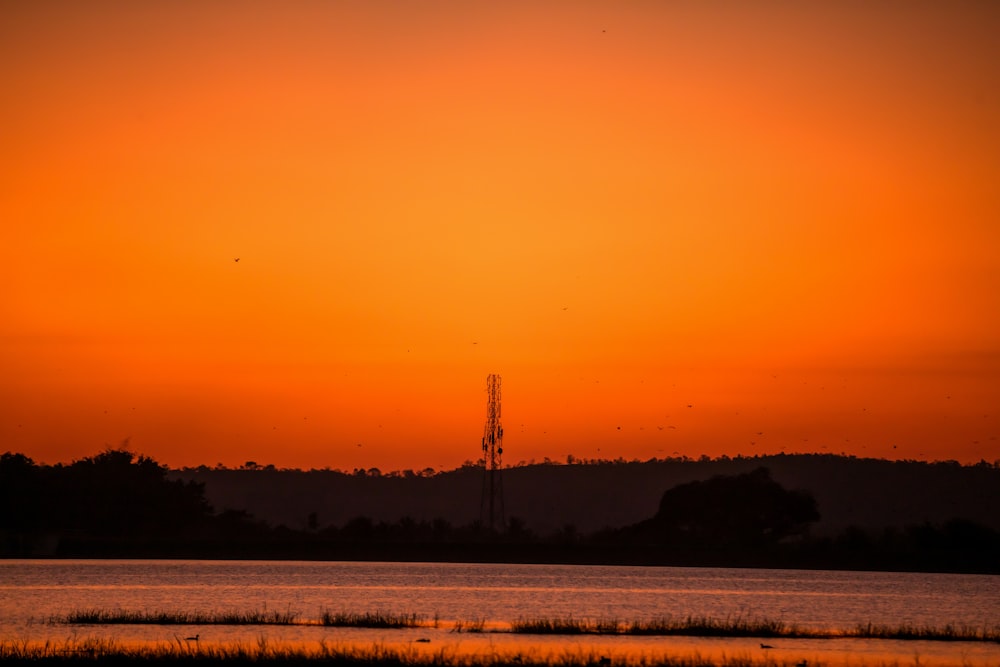 the sun is setting over a body of water