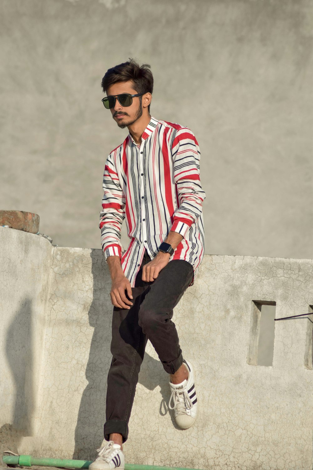 a man riding a skateboard next to a cement wall