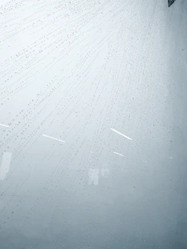 Water droplets gently falling on a treated basement surface with subtle ripple effect.